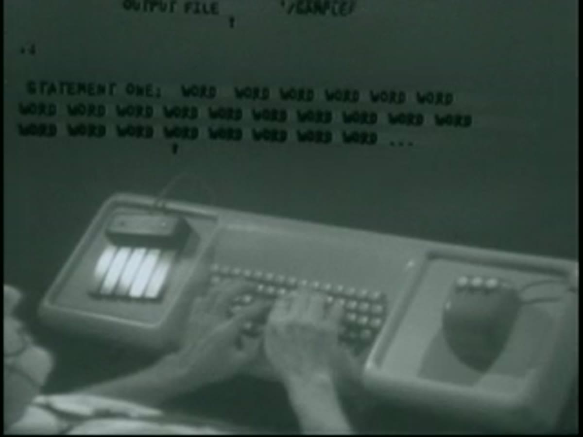 A five-key chord keyset sits beside a keyboard, used alongside the mouse during the demo.