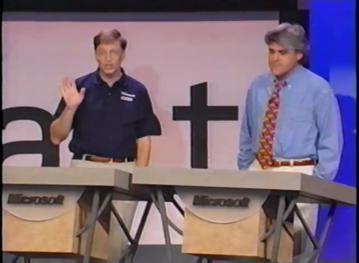 Bill Gates and Jay Leno on stage beside giant set pieces spelling out the word Start.