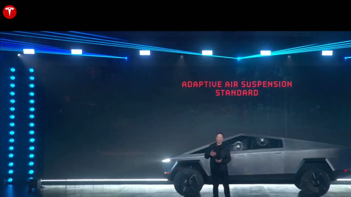 The Cybertruck on stage with an on-screen overlay reading Adaptive Air Suspension.
