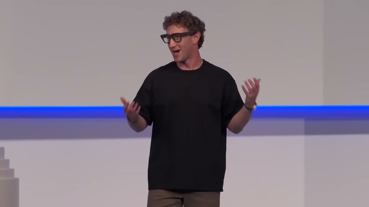A Meta presenter on stage wearing the Ray-Ban Display glasses.