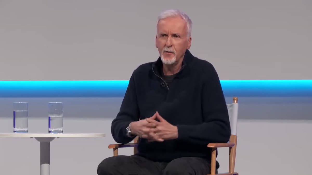 An older man seated on stage during a guest interview segment.